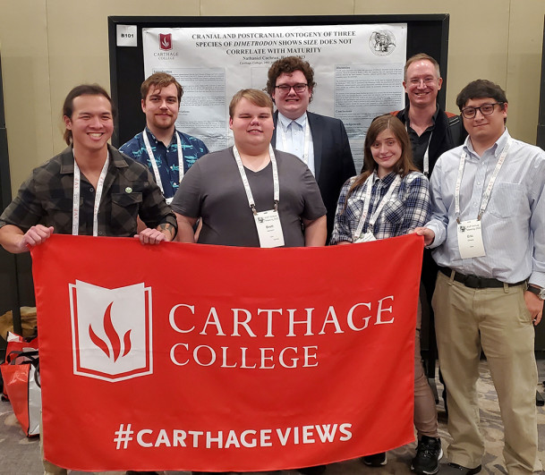 Nathan Cochran (fourth from the left) with his poster presentation, and student colleagues and fa...