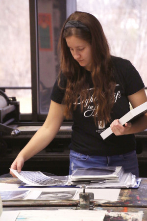 A photography student works on an assignment in class.